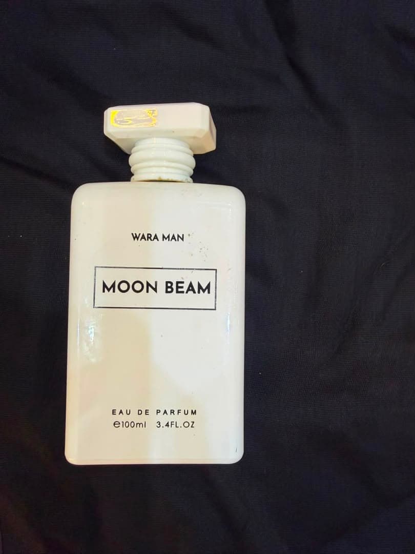 Moon Beam white perfume bottle on dark textured background